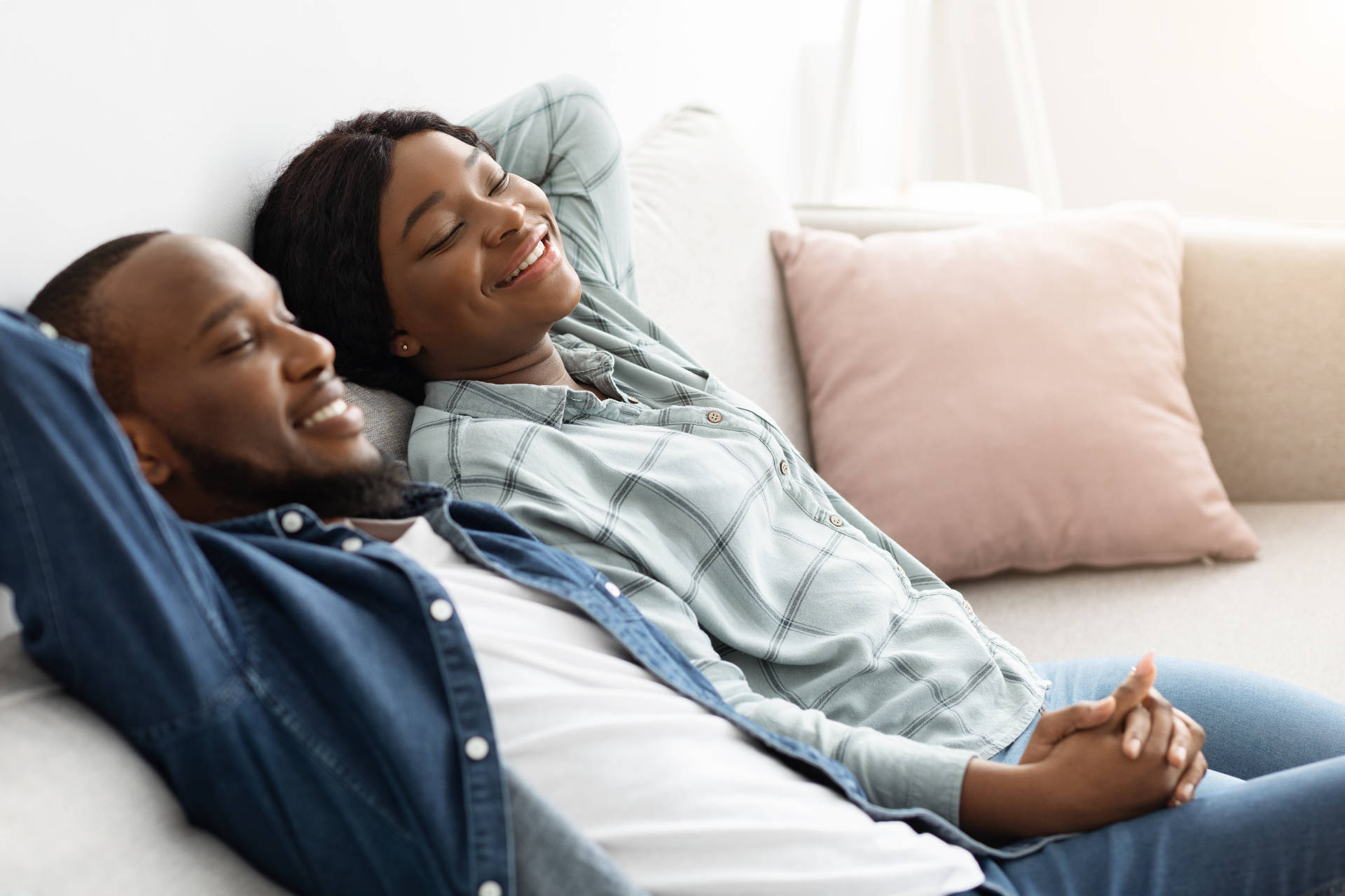 A couple relaxing on the couch in a decluttered home